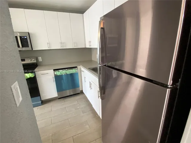 a kitchen with a sink and a stove top oven