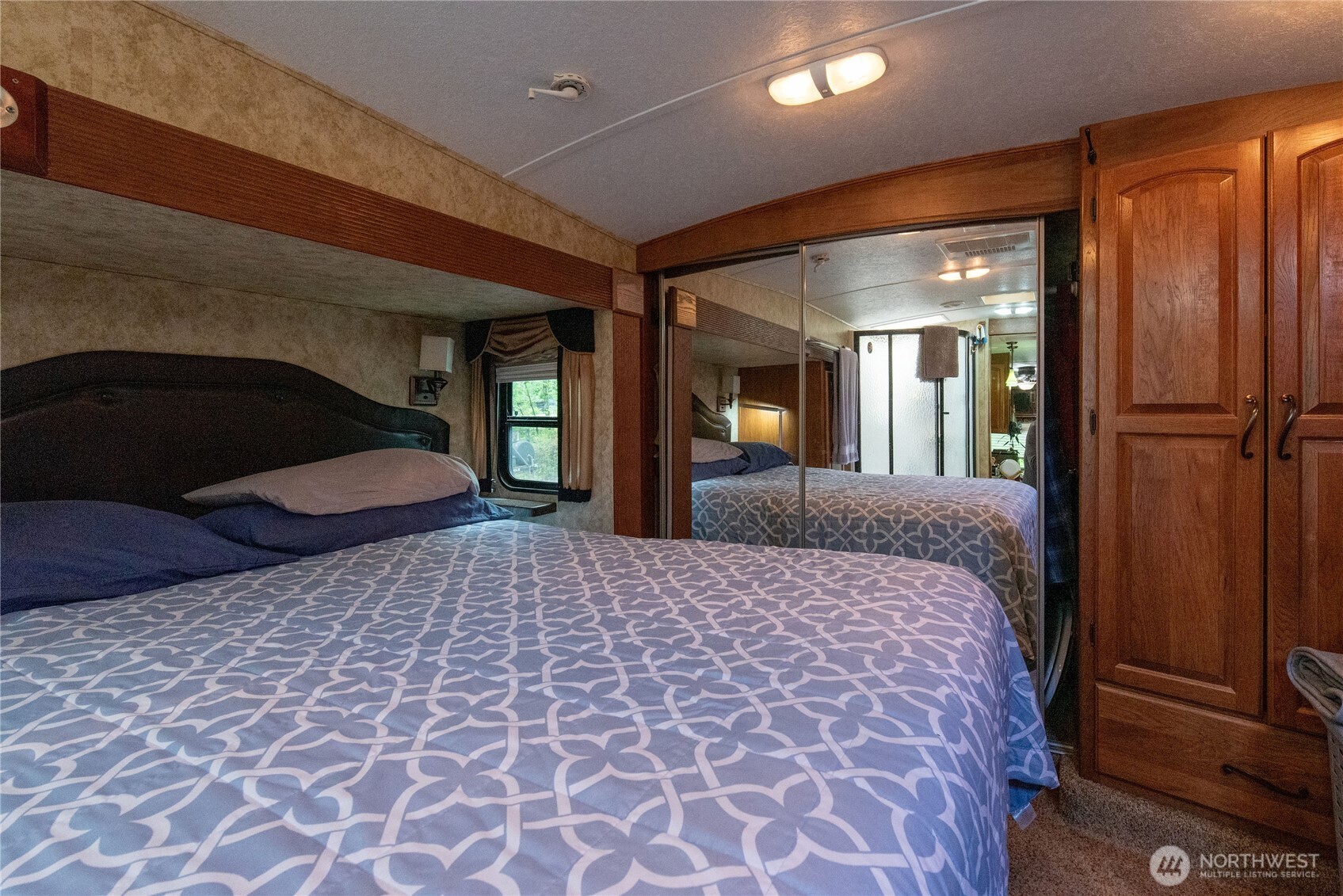 151 East Hillside Drive Belfair, WA 98528 - Photo 19 of 24 a bedroom with a large bed and a chandelier