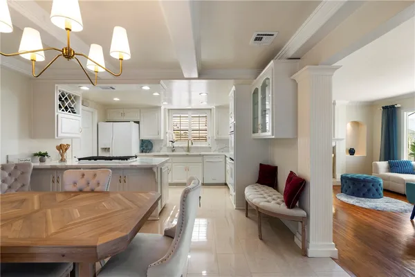 a large kitchen with kitchen island a large counter space a sink appliances and living room view