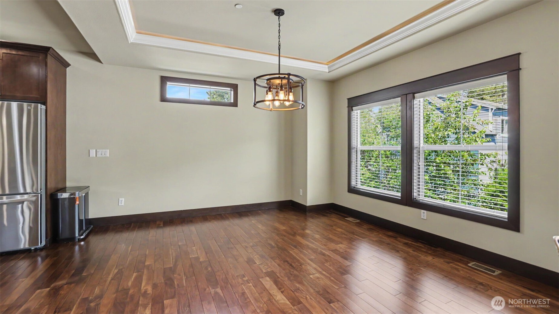1357 Elma Place Northeast Renton, WA 98059 - Photo 4 of 40 a view of an empty room with wooden floor and a window