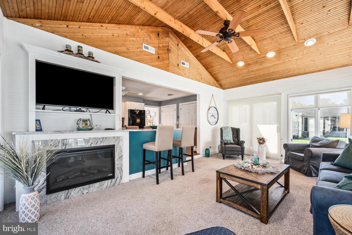 3 Oriole Drive Cambridge, MD 21613 - Photo 18 of 46 a living room with furniture a flat screen tv and a fireplace