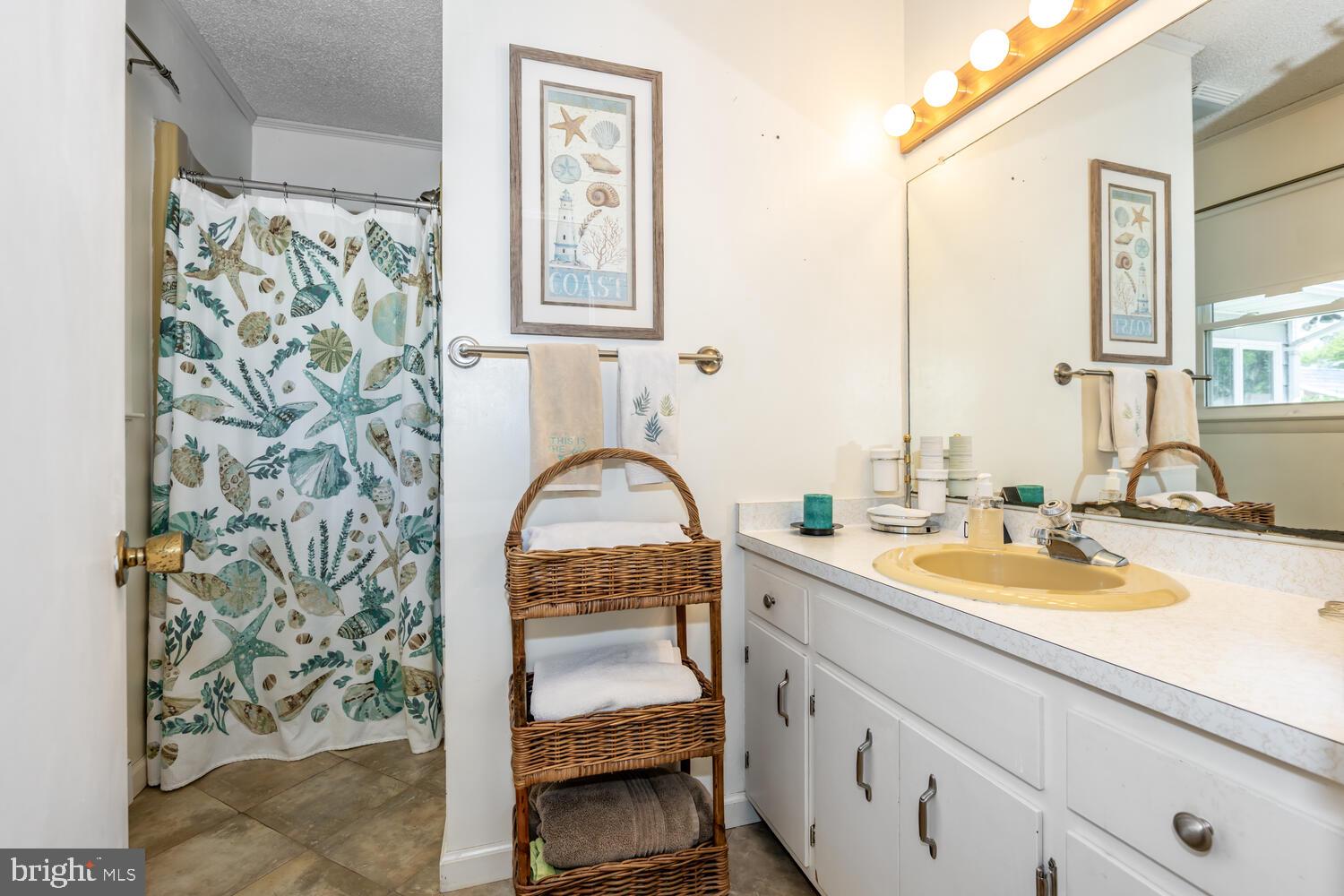 3 Oriole Drive Cambridge, MD 21613 - Photo 27 of 46 a kitchen with a granite countertop sink a stove and a window