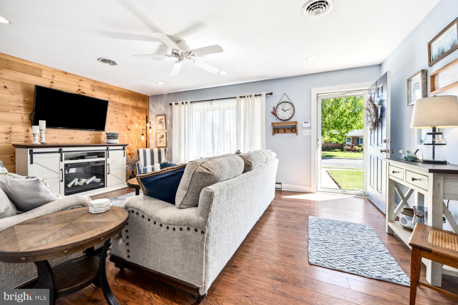 3 Oriole Drive Cambridge, MD 21613 - Photo 6 of 46 a living room with furniture a flat screen tv and a fireplace
