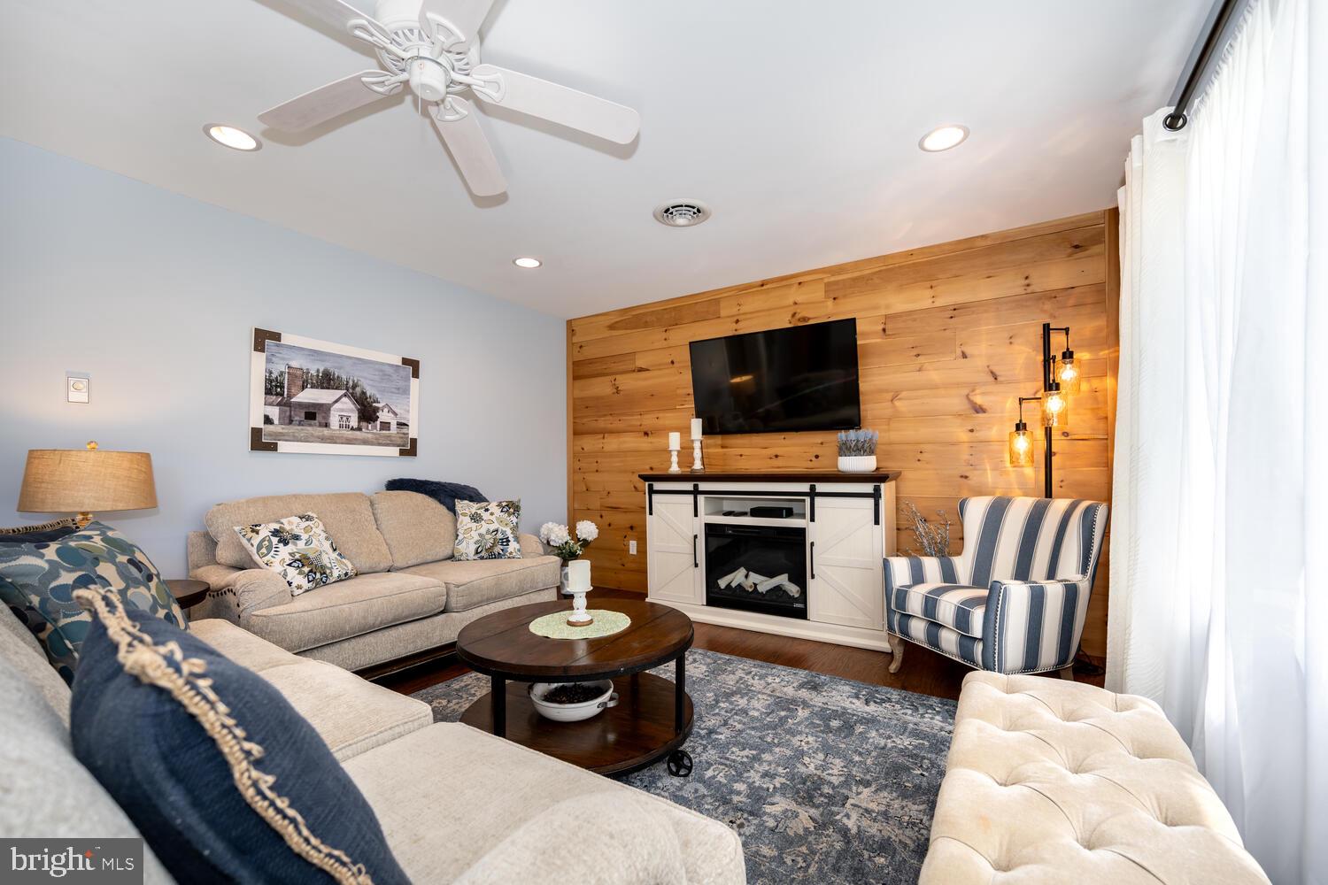 3 Oriole Drive Cambridge, MD 21613 - Photo 8 of 46 a living room with furniture a flat screen tv and a fireplace