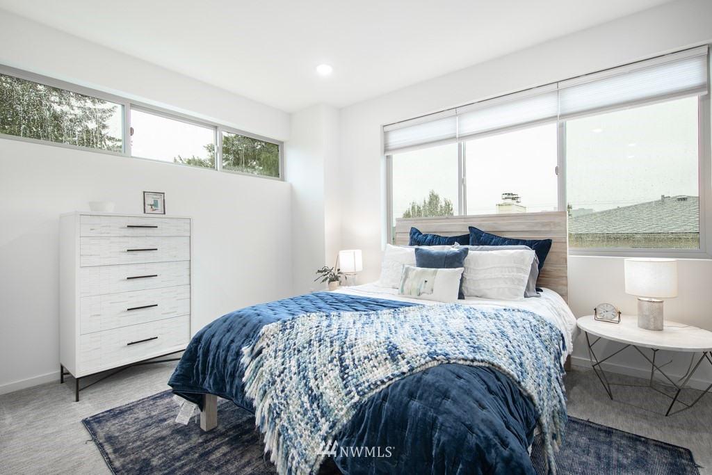 744 North 95th Street, Unit B Seattle, WA 98103 - Photo 11 of 28 a bedroom with a bed a table and chair