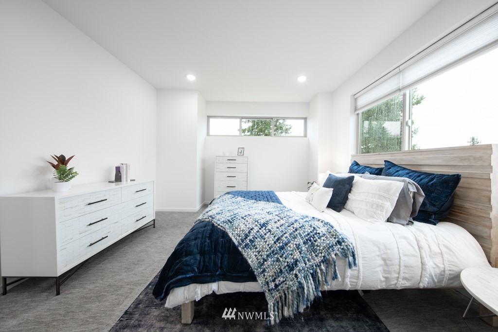 744 North 95th Street, Unit B Seattle, WA 98103 - Photo 12 of 28 a bed room with a bed and a window