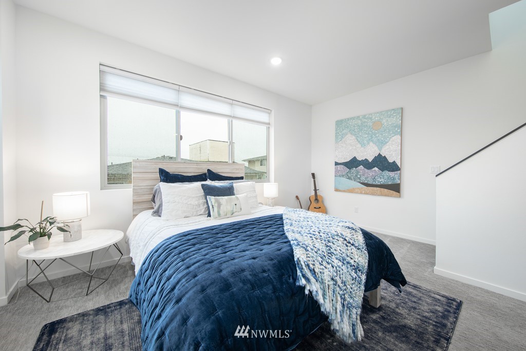 744 North 95th Street, Unit B Seattle, WA 98103 - Photo 13 of 28 a bedroom with a bed and wooden floor