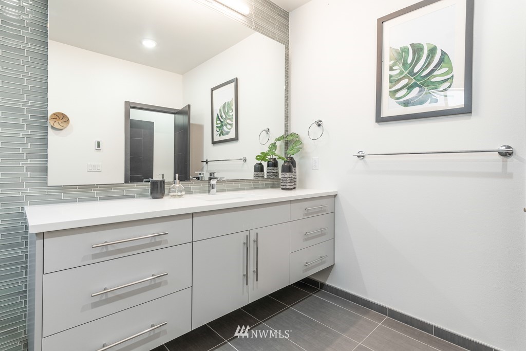 744 North 95th Street, Unit B Seattle, WA 98103 - Photo 17 of 28 a bathroom with a double vanity sink and a mirror