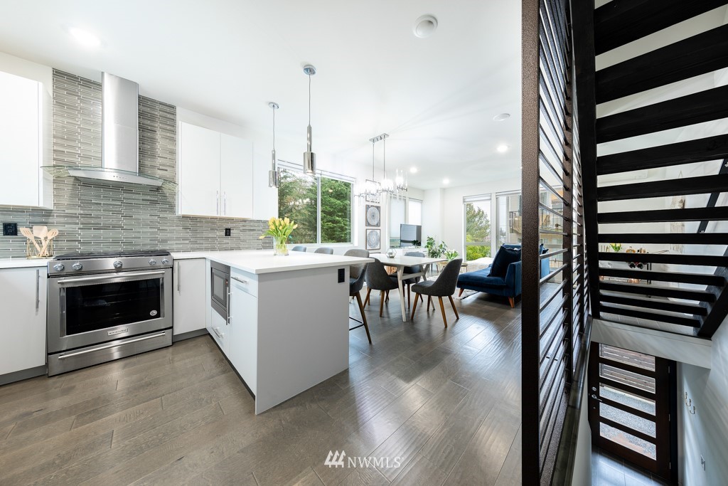 744 North 95th Street, Unit B Seattle, WA 98103 - Photo 2 of 28 a kitchen with a table chairs stove and cabinets