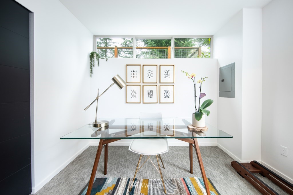 744 North 95th Street, Unit B Seattle, WA 98103 - Photo 22 of 28 a living room with a table and chairs