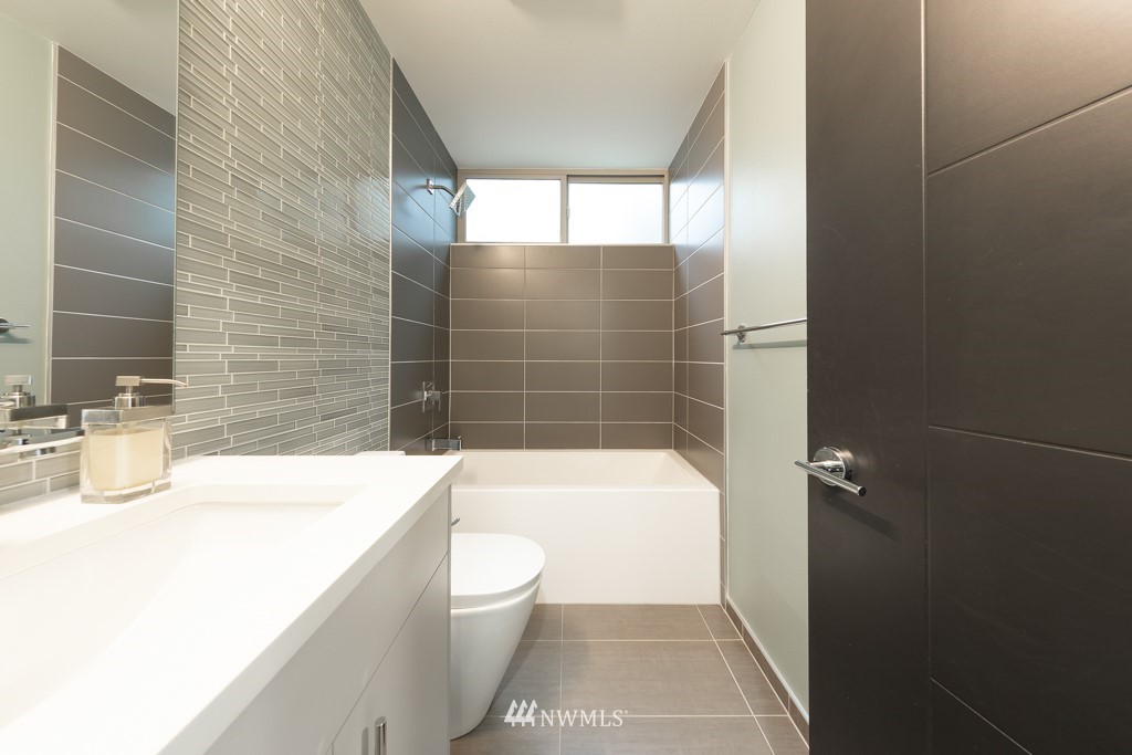 744 North 95th Street, Unit B Seattle, WA 98103 - Photo 24 of 28 a bathroom with a toilet a sink and bathtub