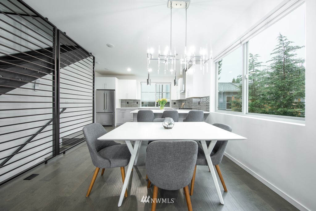 744 North 95th Street, Unit B Seattle, WA 98103 - Photo 7 of 28 a large white kitchen with a table and chairs