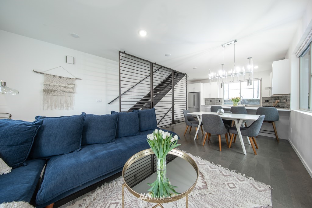 744 North 95th Street, Unit B Seattle, WA 98103 - Photo 10 of 28 a living room with furniture a chandelier and a dining table