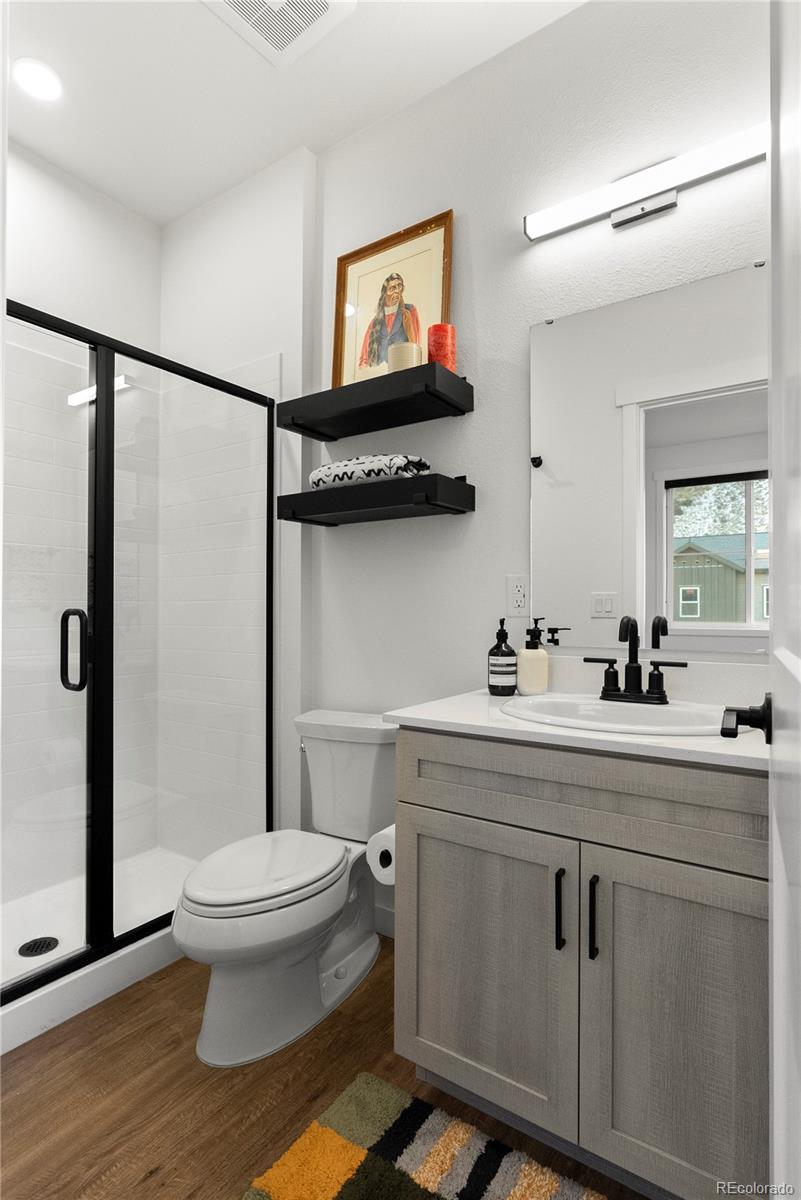 2152 Bighorn Road, Unit 204 Georgetown, CO 80444 - Photo 17 of 36 a bathroom with a toilet sink and mirror