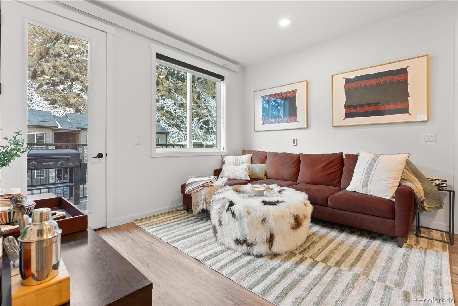 2152 Bighorn Road, Unit 204 Georgetown, CO 80444 - Photo 9 of 36 a living room with furniture large window and wooden floor