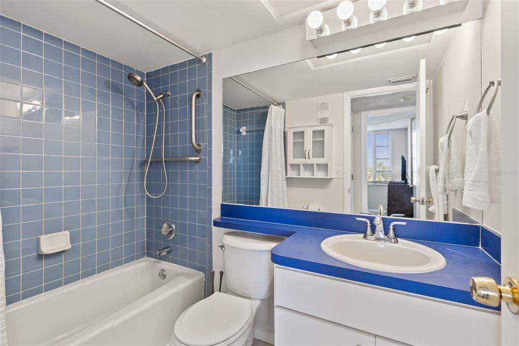 255 Dolphin Point, Unit 513 Clearwater Beach, FL 33767 - Photo 15 of 18 a bathroom with a sink and a mirror