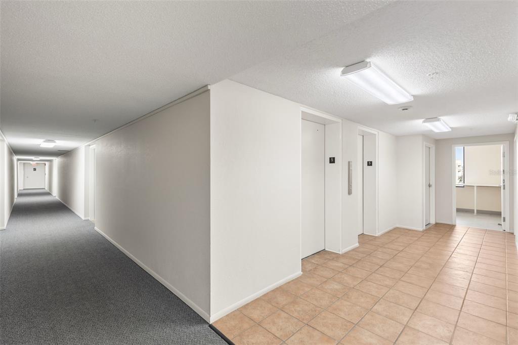 255 Dolphin Point, Unit 513 Clearwater Beach, FL 33767 - Photo 18 of 18 a view of a hallway with closet area