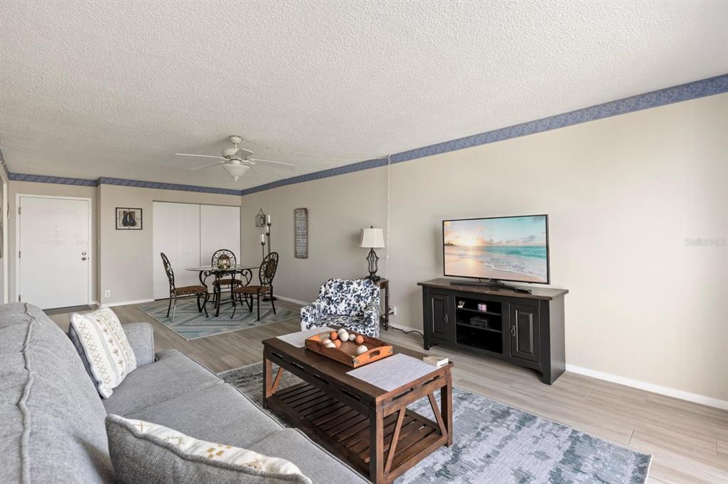 255 Dolphin Point, Unit 513 Clearwater Beach, FL 33767 - Photo 9 of 18 a living room with furniture and wooden floor