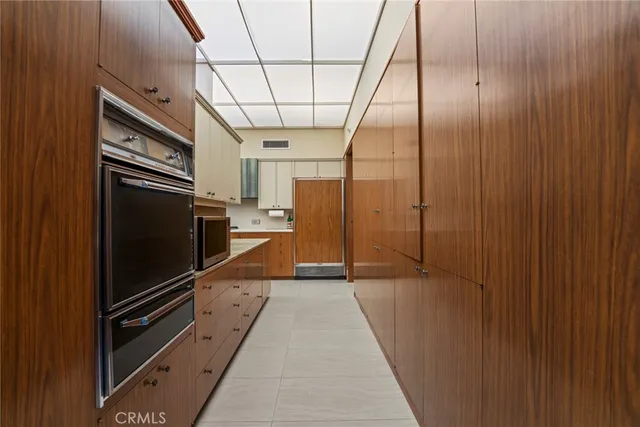 a living room filled with furniture and a floor to ceiling window