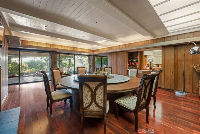 a living room with furniture a large window with kitchen view