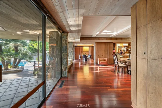 a bed sitting in a spacious bedroom next to a large window