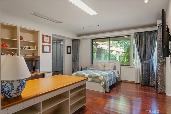 a bedroom with furniture and a large window