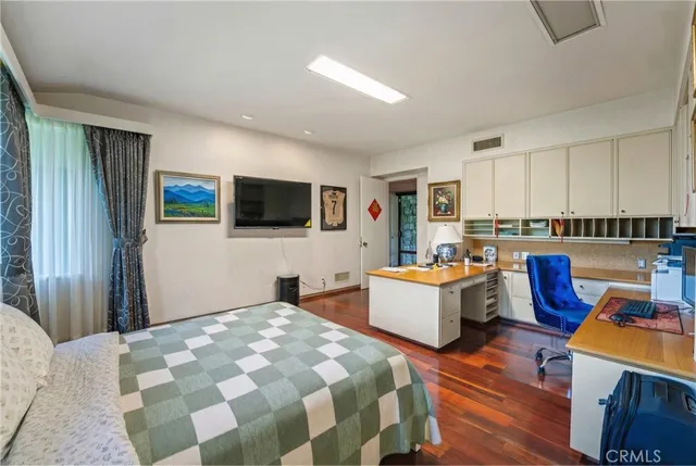 a view of a hallway with a couch and wooden floor
