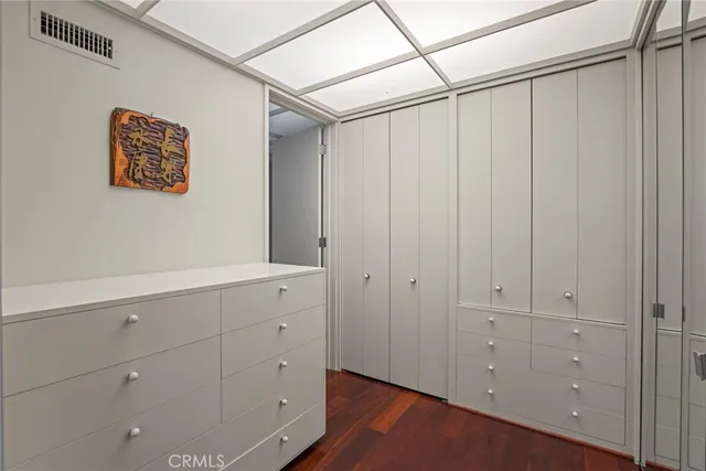 a view of a hallway with wooden floor and windows