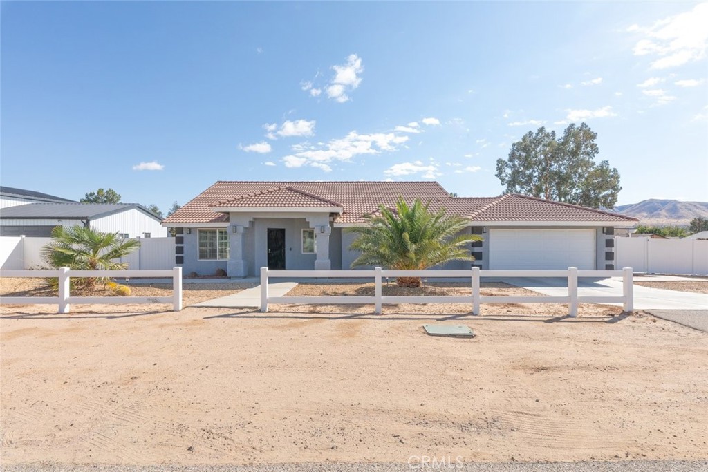 8085 Royce Avenue Hesperia, CA 92345 - Photo 2 of 2 a view of a house with a yard and sitting area