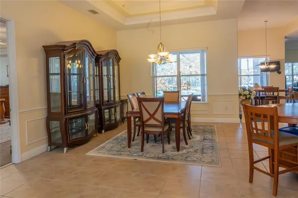 a living room with furniture a window and a chandelier