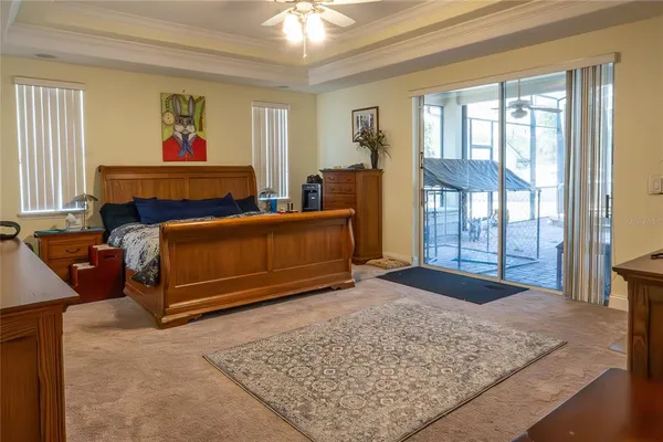 a living room with furniture a fireplace and a large window