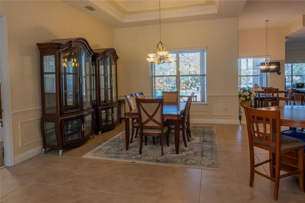 a kitchen with kitchen island granite countertop a sink stove and refrigerator