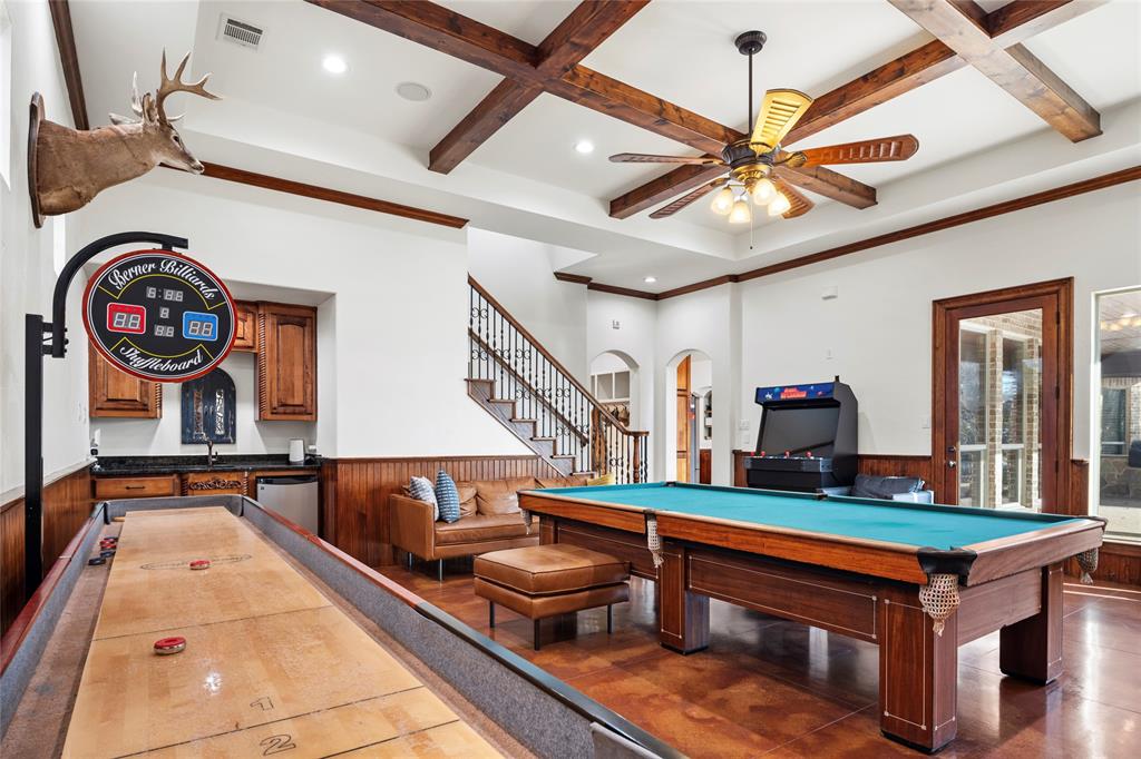 700 Frenchtown Road Argyle, TX 76226 - Photo 24 of 40 Impressive beamed ceiling in game room with exterior door to access covered outdoor living area.