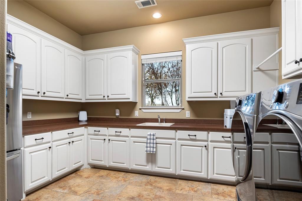 700 Frenchtown Road Argyle, TX 76226 - Photo 26 of 40 WOW! Talk about a dream Laundry room, well here it is. Tons of cabinet space for storage.