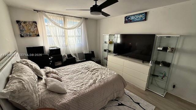 4502 North Federal Highway, Unit 336D Lighthouse Point, FL 33064 - Photo 9 of 20 a bedroom with a bed and a flat tv screen on the dresser