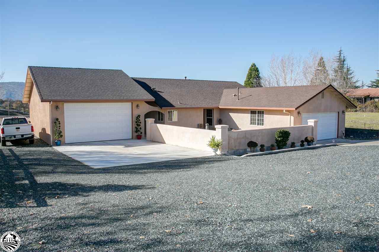 2112 Quail Hill Road Copperopolis, CA 95228 - Photo 1 of 22 a front view of a house with a yard and garage