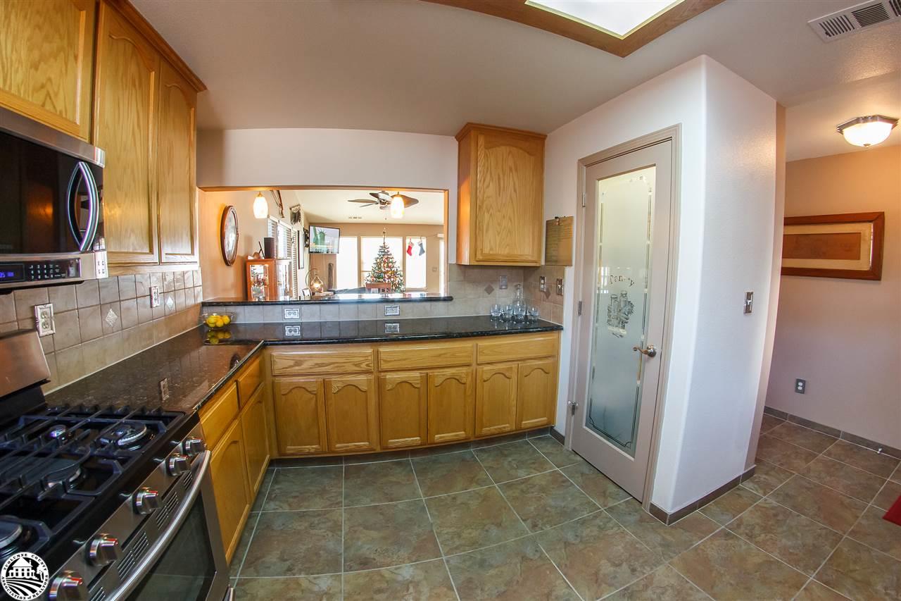 2112 Quail Hill Road Copperopolis, CA 95228 - Photo 12 of 22 a kitchen with stainless steel appliances granite countertop a stove a sink and a refrigerator