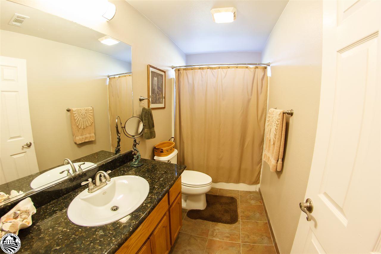 2112 Quail Hill Road Copperopolis, CA 95228 - Photo 16 of 22 a bathroom with a granite countertop sink and a mirror
