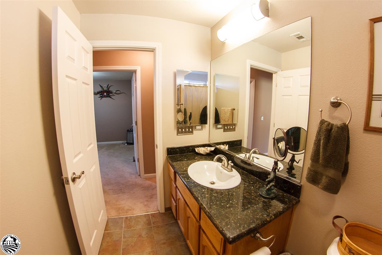 2112 Quail Hill Road Copperopolis, CA 95228 - Photo 17 of 22 a bathroom with sink granite countertop tub and a mirror
