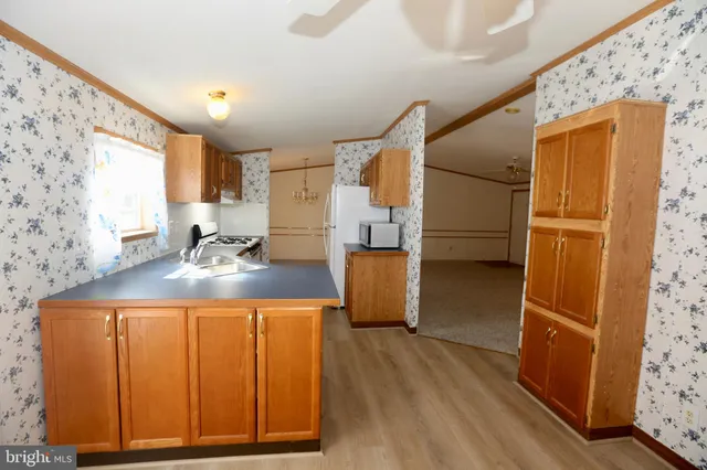 a kitchen with granite countertop a refrigerator and a stove