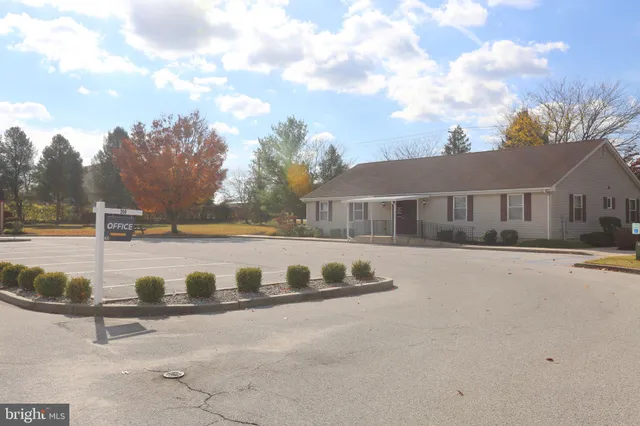 a view of swimming pool with outdoor seating and house in the background