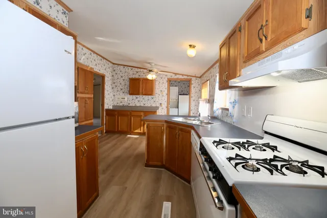 a kitchen with stainless steel appliances a stove a sink and a refrigerator