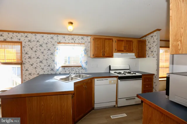 a kitchen with stainless steel appliances a sink stove and cabinets