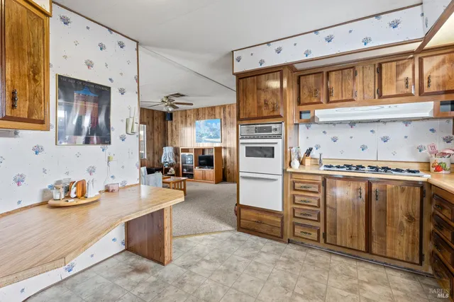 a kitchen with stainless steel appliances a stove and more cabinets