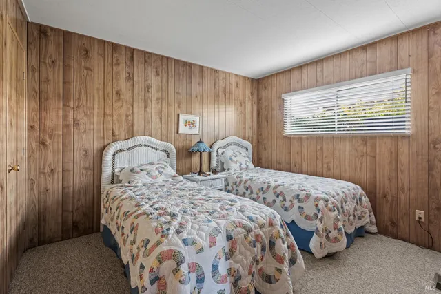 a bedroom with two beds and a dresser