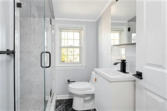 a bathroom with a toilet sink and shower