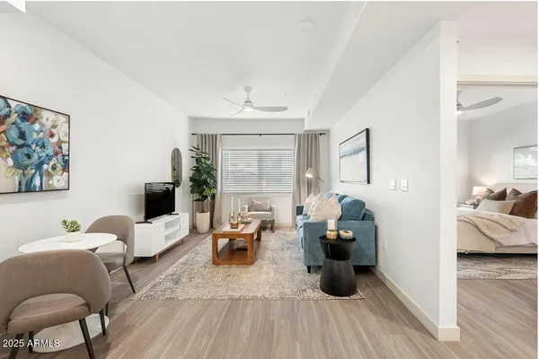 a living room with furniture and a wooden floor