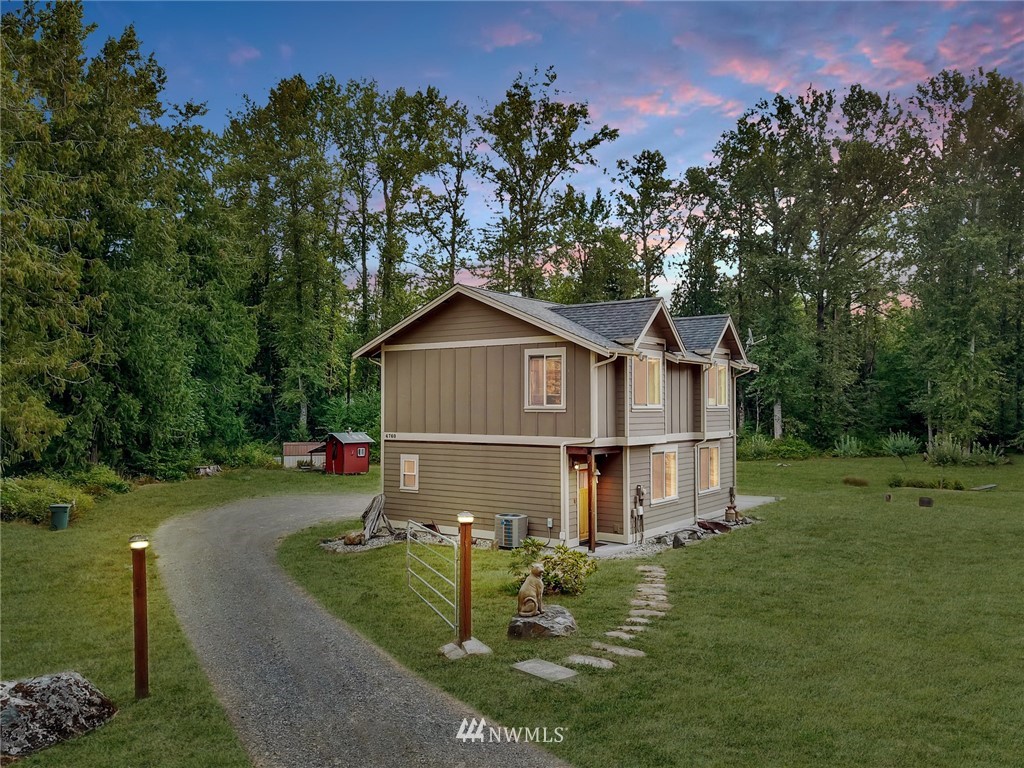4760 Mission Road Bellingham, WA 98226 - Photo 2 of 40 a view of a small house with a yard