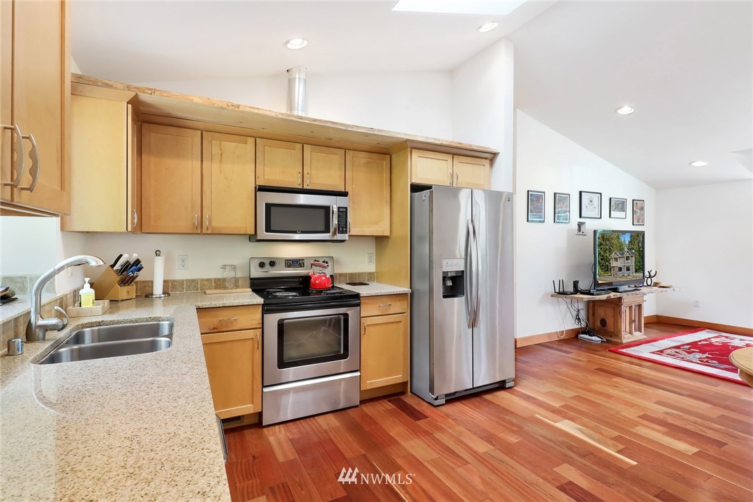 4760 Mission Road Bellingham, WA 98226 - Photo 13 of 40 a kitchen with stainless steel appliances granite countertop a refrigerator stove and sink