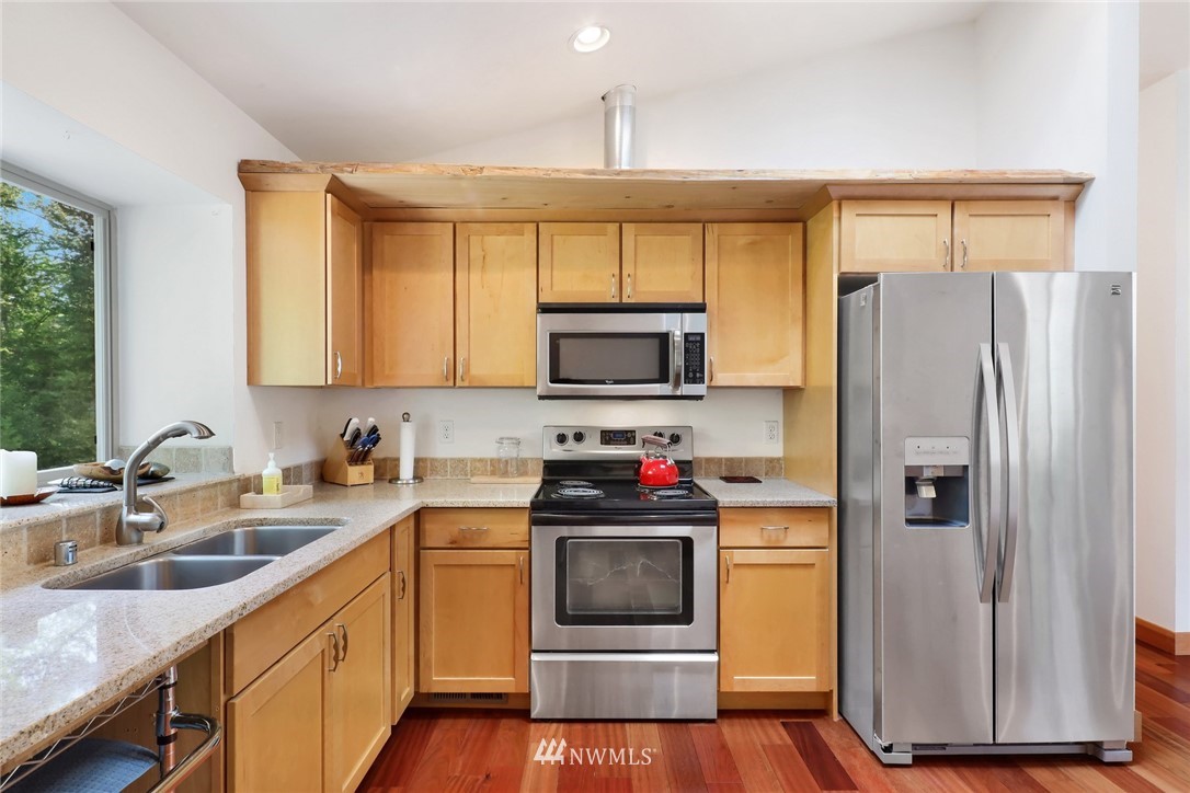 4760 Mission Road Bellingham, WA 98226 - Photo 14 of 40 a kitchen with a sink stove and refrigerator